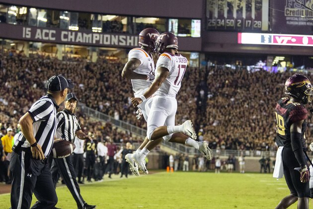 Virginia Tech Hokies wide receiver Damon Hazelton, left, and quarterback quarterback Josh Jackson (17) celebrate a touchdown on their first drive against Florida State during an NCAA college football game in Tallahassee, Fla., Monday, Sept. 3, 2018. (AP Photo/Mark Wallheiser)
