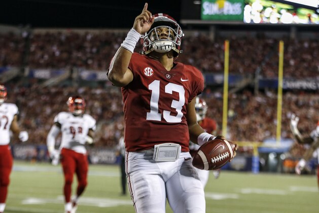 ORLANDO, FL - SEPTEMBER 1: Quarterback Tua Tagovailoa #13 of the Alabama Crimson Tide points to the sky while celebrates after a score during the game against the Louisville Cardinals during the Camping World Kickoff at Camping World Stadium on September 1, 2018 in Orlando, Florida. #1 ranked Alabama defeated Louisville 51 to 14. (Photo by Don Juan Moore/Getty Images)