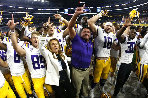 LSU head coach Ed Orgeron celebrates with his team following their 33-17 win over LSU in an NCAA college football game Sunday, Sept. 2, 2018, in Arlington, Texas. (AP Photo/Ron Jenkins)