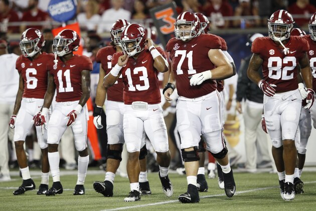 ORLANDO, FL - SEPTEMBER 01: Tua Tagovailoa #13 of the Alabama Crimson Tide leads his teammates onto the field during a game against the Louisville Cardinals at Camping World Stadium on September 1, 2018 in Orlando, Florida. Alabama won 51-14. (Photo by Joe Robbins/Getty Images)
