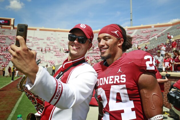 NORMAN, OK - SEPTEMBER 01: Running back Rodney Anderson #24 of the Oklahoma Sooners takes a selfie with a fan after the game against the Florida Atlantic Owls at Gaylord Family Oklahoma Memorial Stadium on September 1, 2018 in Norman, Oklahoma. The Sooners defeated the Owls 63-14. (Photo by Brett Deering/Getty Images)