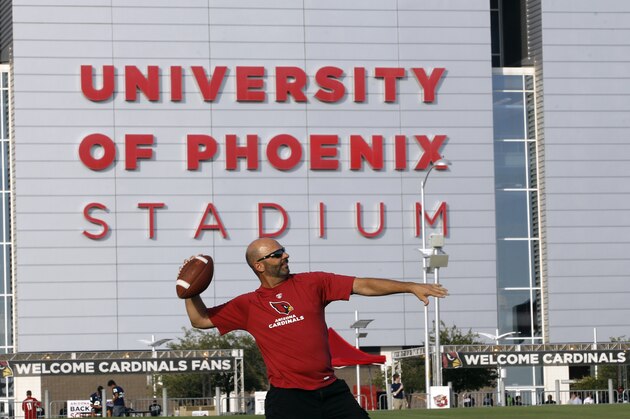 Arizona Cardinals fan Don Egler throws a football in front of University of Phoenix Stadium before an NFL preseason football game between the Oakland Raiders and the Arizona Cardinals, Friday, Aug. 12, 2016, in Glendale, Ariz. (AP Photo/Ralph Freso)