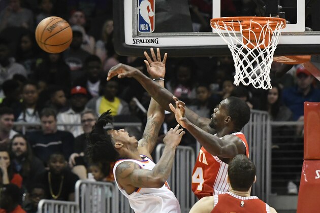 Atlanta Hawks center Dewayne Dedmon (14) blocks a shot by Phoenix Suns guard Elfrid Payton, left, during the second half of an NBA basketball game Sunday, March 4, 2018, in Atlanta. (AP Photo/John Amis)