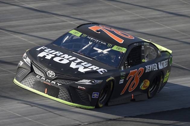 FILE - In this Oct. 1, 2017, file photo, Martin Truex Jr. competes during the NASCAR Cup Series auto race, at Dover International Speedway in Dover, Del. Furniture Row Racing will cease operations at the end of this season, shutting its doors one year after Martin Truex Jr. won NASCAR’s championship driving for the maverick race team. Furniture Row is an anomaly in NASCAR in that it is a single-car team based in Denver, Colorado, far removed from the North Carolina hub. Team owner Barney Visser was a racing enthusiast with a vision when he launched the team in 2005 determined to do it his own way. But a lack of sponsorship for next season led Visser to make the “painful decision” to close the team. (AP Photo/Nick Wass, File)