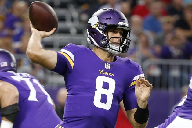 FILE - In this Aug. 24, 2018, file photo, Minnesota Vikings quarterback Kirk Cousins (8) throws a pass during the first half of an NFL preseason football game against the Seattle Seahawks, in Minneapolis. The Vikings begin their defense of the NFC North title with a shiny new quarterback and a handful of enhancements to an already stout defense, but the rival Green Bay Packers aren't going away. And Aaron Rodgers is back, eager to make up for lost time following the broken collarbone that spoiled his 2017 season.(AP Photo/Bruce Kluckhohn, File)