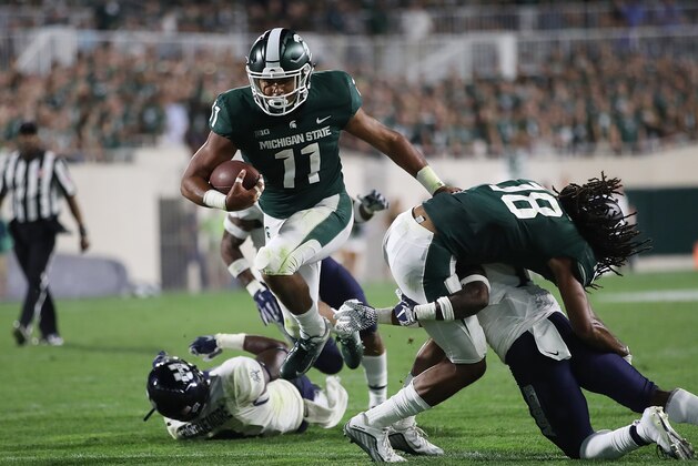EAST LANSING, MI - AUGUST 31: Connor Heyward #11 of the Michigan State Spartans scores a third quarter touchdown while playing the Utah State Aggies at Spartan Stadium on August 31, 2018 in East Lansing, Michigan. Michigan State won the game 38-31. (Photo by Gregory Shamus/Getty Images)