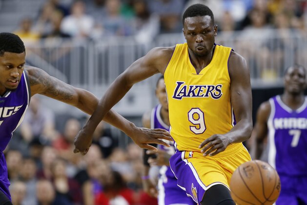 Los Angeles Lakers' Luol Deng (9) and Sacramento Kings' Rudy Gay scramble for a loose ball during the first half of an NBA preseason basketball game Thursday, Oct. 13, 2016, in Las Vegas. (AP Photo/Isaac Brekken)