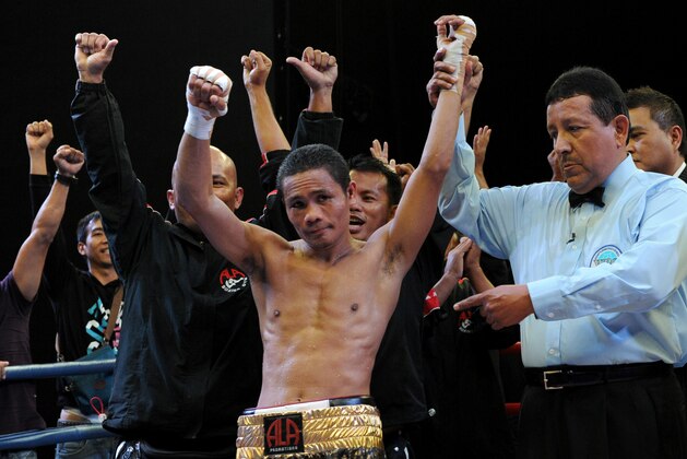 World Boxing Organization light-flyweight champion Donnie Nietes (C) of the Philippines celebrates after defeating Mexican challenger Felipe Salguero on June 2, 2012 during a WBO light-flyweight title bout in Manila, retaining his title.               AFP PHOTO / Jay DIRECTO        (Photo credit should read JAY DIRECTO/AFP/GettyImages)