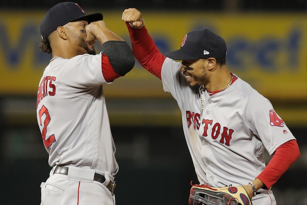 Boston Red Sox's Mookie Betts, right, and Xander Bogaerts celebrate the team's 9-4 win over the Chicago White Sox in a baseball game Thursday, Aug. 30, 2018, in Chicago. (AP Photo/Jim Young)