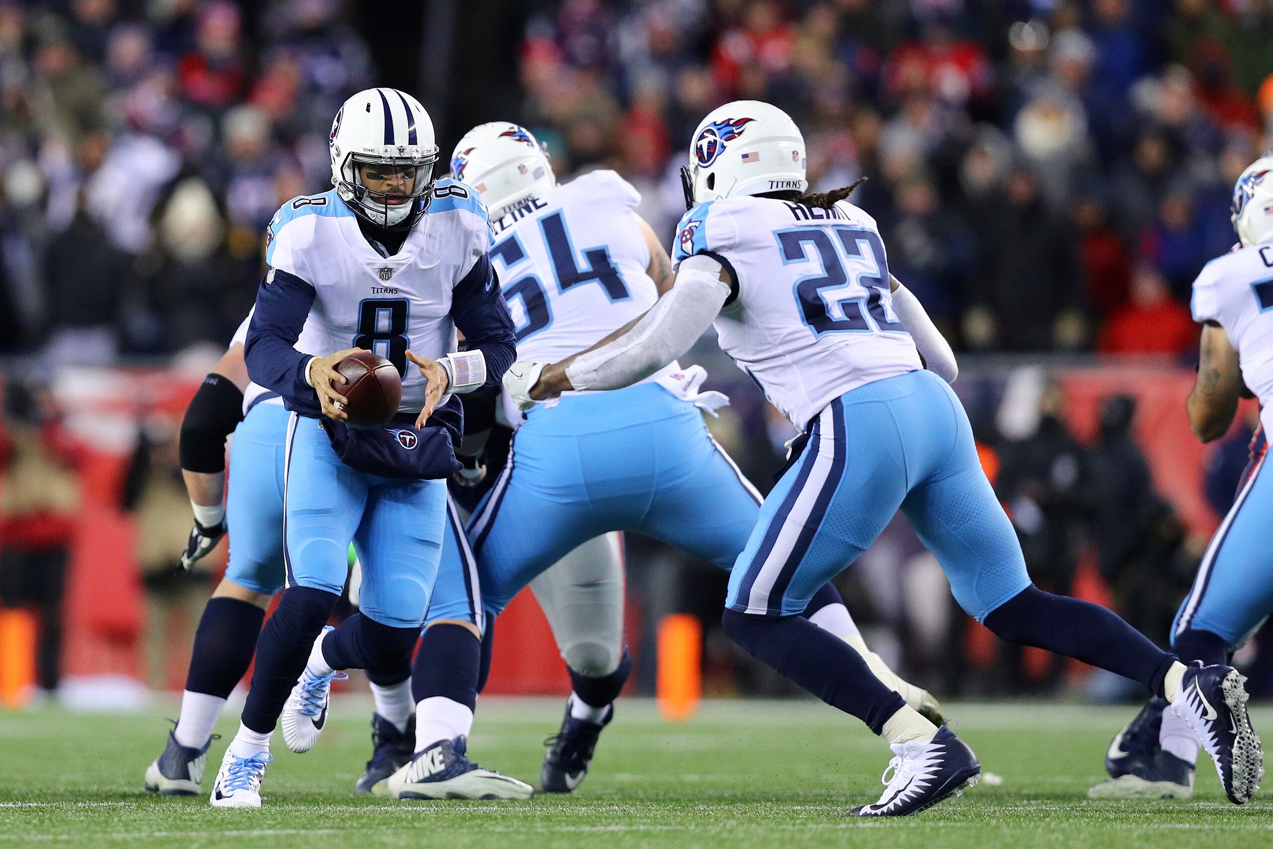 FOXBOROUGH, MA - JANUARY 13:  Marcus Mariota #8 of the Tennessee Titans hands the ball offsides to Derrick Henry #22 in the second quarter of the AFC Divisional Playoff game against the New England Patriots at Gillette Stadium on January 13, 2018 in Foxborough, Massachusetts.  (Photo by Maddie Meyer/Getty Images)