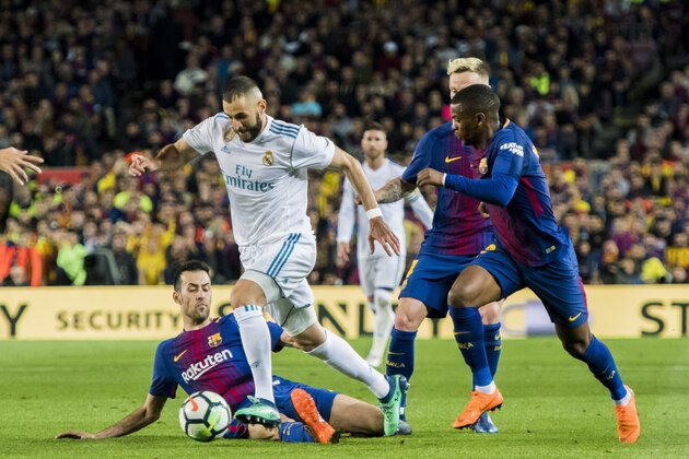 BARCELONA, SPAIN - MAY 06: Karim Benzema (2nd from L) of Real Madrid vies for the ball with Sergio Busquets Burgos (L) of FC Barcelona during the La Liga match between Barcelona and Real Madrid at Camp Nou on May 6, 2018 in Barcelona, Spain. (Photo by Power Sport Images/Getty Images)