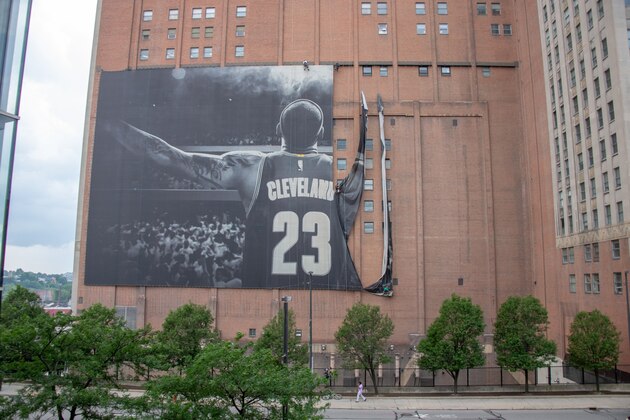 CLEVELAND, OH - JULY 3: Workers remove the Nike LeBron James banner from the Sherwin-Williams building near Quicken Loans Arena on July 3, 2018 in Cleveland, Ohio. NOTE TO USER: User expressly acknowledges and agrees that, by downloading and or using this photograph, User is consenting to the terms and conditions of the Getty Images License Agreement. (Photo by Jason Miller/Getty Images)