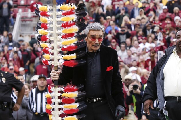 TALLAHASSEE, FL - NOVEMBER 22: Former Florida State football player, actor Burt Reynolds plants the spear mid-field before the game against the Boston College Eagles at Doak Campbell Stadium on Bobby Bowden Field on November 22, 2014 in Tallahassee, Florida. (Photo by Don Juan Moore/Getty Images)