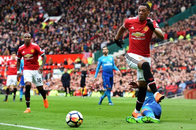 Manchester United's French striker Anthony Martial runs with the ball during the English Premier League football match between Manchester United and Arsenal at Old Trafford in Manchester, north west England, on April 29, 2018. (Photo by Paul ELLIS / AFP) / RESTRICTED TO EDITORIAL USE. No use with unauthorized audio, video, data, fixture lists, club/league logos or 'live' services. Online in-match use limited to 75 images, no video emulation. No use in betting, games or single club/league/player publications. /         (Photo credit should read PAUL ELLIS/AFP/Getty Images)