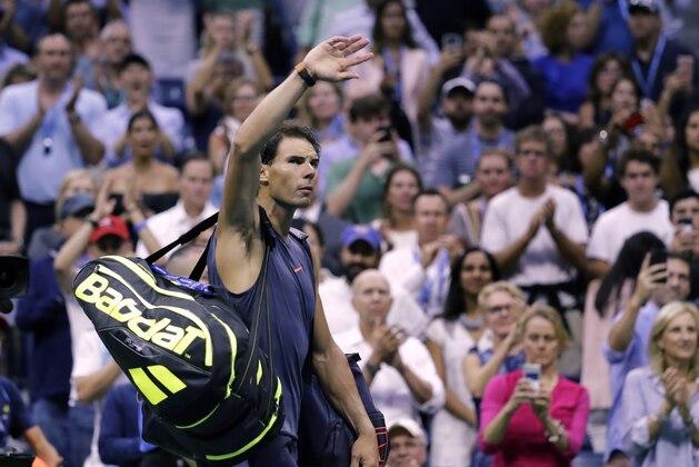 Rafael Nadal, of Spain, waves to fans after retiring from a match against Juan Martin del Potro, of Argentina, during the semifinals of the U.S. Open tennis tournament, Friday, Sept. 7, 2018, in New York. (AP Photo/Seth Wenig)