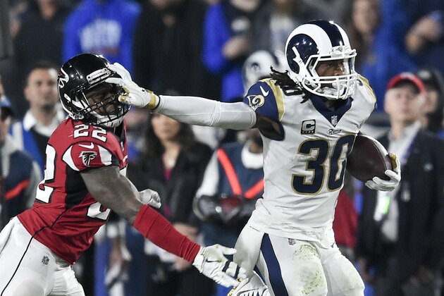 Los Angeles Rams running back Todd Gurley, right, pushes off Atlanta Falcons strong safety Keanu Neal during the first half of an NFL football wild-card playoff game Saturday, Jan. 6, 2018, in Los Angeles. (AP Photo/Kelvin Kuo)
