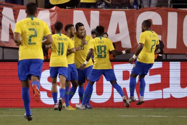 Brazil forward Roberto Firmino, center, is congratulated by teammates after scoring a goal against the United States during the first half of an international soccer friendly match, Friday, Sept. 7, 2018, in East Rutherford, N.J. (AP Photo/Julio Cortez)