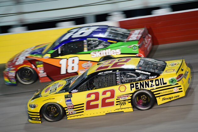 DARLINGTON, SC - SEPTEMBER 02:  Joey Logano, driver of the #22 Pennzoil Ford, races Kyle Busch, driver of the #18 Skittles 1998 Retro Toyota, during the Monster Energy NASCAR Cup Series Bojangles' Southern 500 at Darlington Raceway on September 2, 2018 in Darlington, South Carolina.  (Photo by Jared C. Tilton/Getty Images)