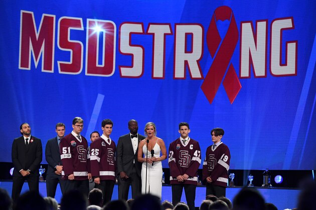 LAS VEGAS, NV - JUNE 20:  NHL Network sportscasters Anson Carter (3rd L) and Kathryn Tappen (4th L) present an award with Marjory Stoneman Douglas High School hockey team members (L-R) Adam Hauptman, Jesse Guttenberg, Matthew Hauptman and Justin Colton during the 2018 NHL Awards presented by Hulu at The Joint inside the Hard Rock Hotel & Casino on June 20, 2018 in Las Vegas, Nevada.  (Photo by Ethan Miller/Getty Images)