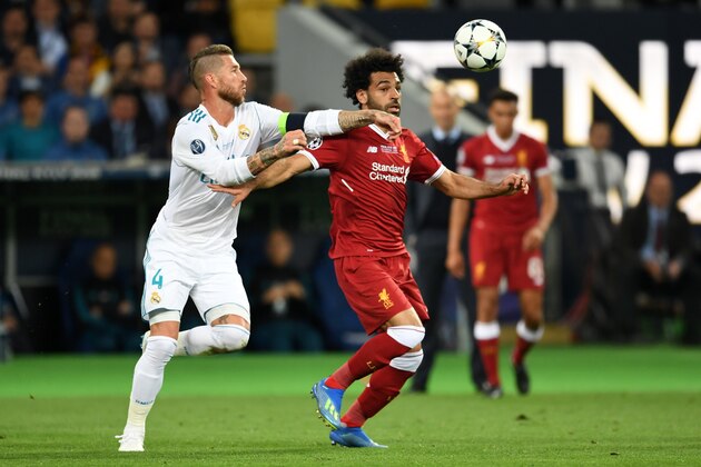 KIEV, UKRAINE - MAY 26: Mohamed Salah of Liverpool and Sergio Ramos of Real Madrid compete for the ball during the UEFA Champions League final between Real Madrid and Liverpool at NSC Olimpiyskiy Stadium on May 26, 2018 in Kiev, Ukraine. (Photo by Etsuo Hara/Getty Images)