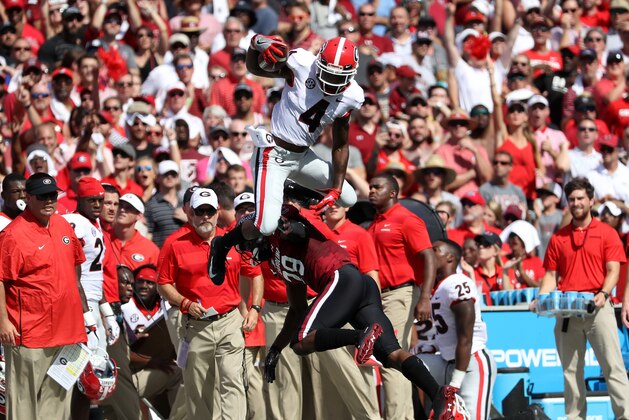 COLUMBIA, SC - SEPTEMBER 08:  Mecole Hardman #4 of the Georgia Bulldogs jumps over J.T. Ibe #29 of the South Carolina Gamecocks during their game at Williams-Brice Stadium on September 8, 2018 in Columbia, South Carolina.  (Photo by Streeter Lecka/Getty Images)