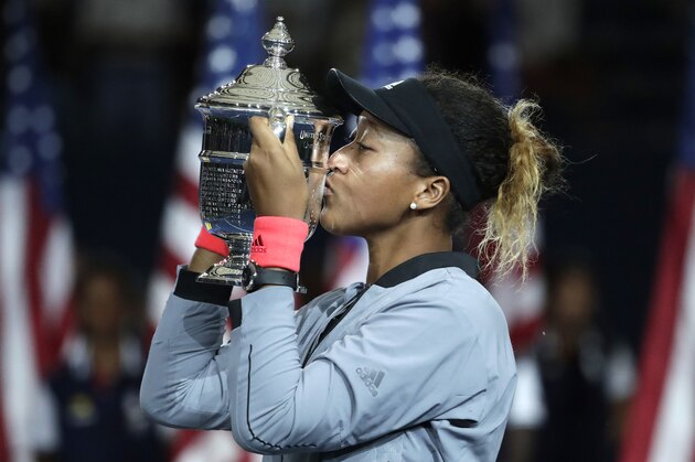Naomi Osaka, of Japan, kisses the trophy after defeating Serena Williams in the women's final of the U.S. Open tennis tournament, Saturday, Sept. 8, 2018, in New York. (AP Photo/Julio Cortez)