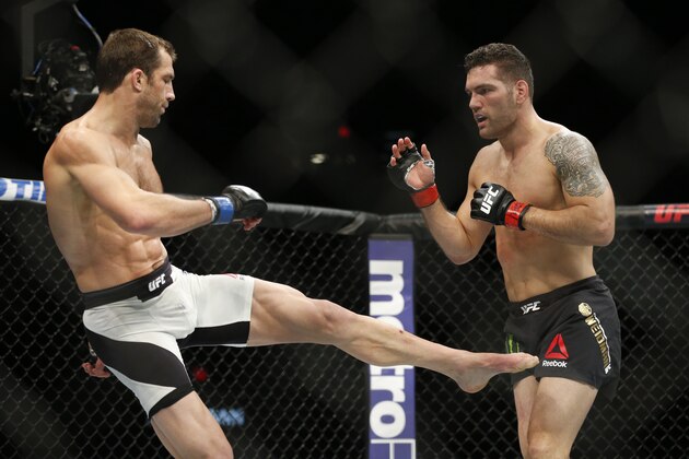Chris Weidman, right, fights Luke Rockhold in a middleweight  championship mixed martial arts bout at UFC 194, Saturday, Dec. 12, 2015, in Las Vegas. (AP Photo/John Locher)