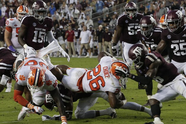 COLLEGE STATION, TX - SEPTEMBER 08:  Adam Choice #26 of the Clemson Tigers is stopped by Donovan Wilson #6 of the Texas A&M Aggies in the second quarter at Kyle Field on September 8, 2018 in College Station, Texas.  (Photo by Bob Levey/Getty Images)