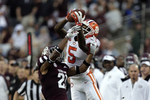COLLEGE STATION, TX - SEPTEMBER 08:  Tee Higgins #5 of the Clemson Tigers leaps over Charles Oliver #21 of the Texas A&M Aggies to make a catch and runs for a 64 yard touchdown in the second quarter at Kyle Field on September 8, 2018 in College Station, Texas.  (Photo by Bob Levey/Getty Images)