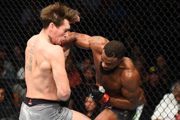 DALLAS, TX - SEPTEMBER 08:  (R-L) Tyron Woodley punches Darren Till of England in their UFC welterweight championship fight during the UFC 228 event at American Airlines Center on September 8, 2018 in Dallas, Texas. (Photo by Josh Hedges/Zuffa LLC/Zuffa LLC via Getty Images)