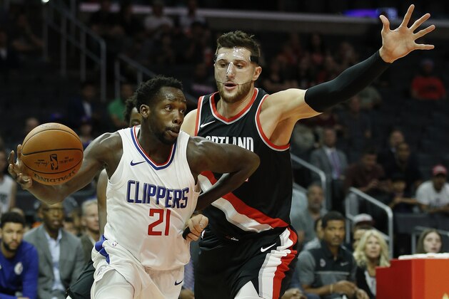 Los Angeles Clippers guard Patrick Beverley, left, drives around Portland Trail Blazers center Jusuf Nurkic during the first half of a preseason NBA basketball game in Los Angeles, Sunday, Oct. 8, 2017. (AP Photo/Alex Gallardo)