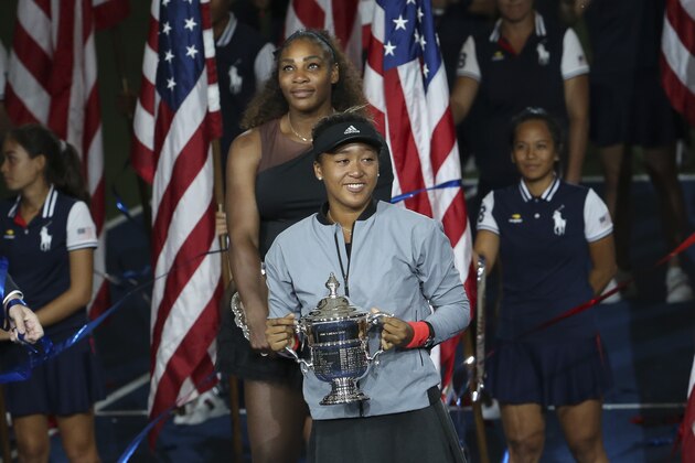 NEW YORK, NY - SEPTEMBER 8: Winner of the 2018 US Open Naomi Osaka of Japan, finalist Serena Williams of USA (behind) during the trophy ceremony following the women's final on day 13 of the 2018 US Open at Arthur Ashe Stadium of USTA Billie Jean King National Tennis Center on September 8, 2018 in Flushing Meadows, Queens, New York City. (Photo by Jean Catuffe/Getty Images)