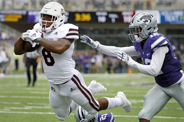 Mississippi State running back Kylin Hill (8) gets past Kansas State defensive backs AJ Parker (12) and Kendall Adams (21) to score a touchdown on a 16-yard run during the first half of an NCAA college football game Saturday, Sept. 8, 2018, in Manhattan, Kan. (AP Photo/Charlie Riedel)