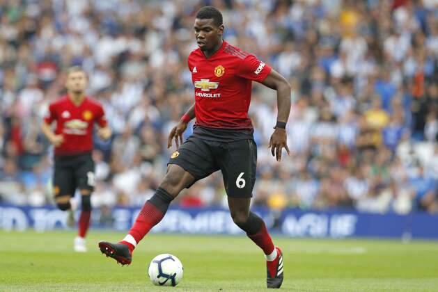 Manchester United's Paul Pogba runs with the ball during the English Premier League soccer match between Brighton and Hove Albion and Manchester United at the Amex stadium in Brighton, England, Sunday, Aug.19, 2018. (AP Photo/Alastair Grant)