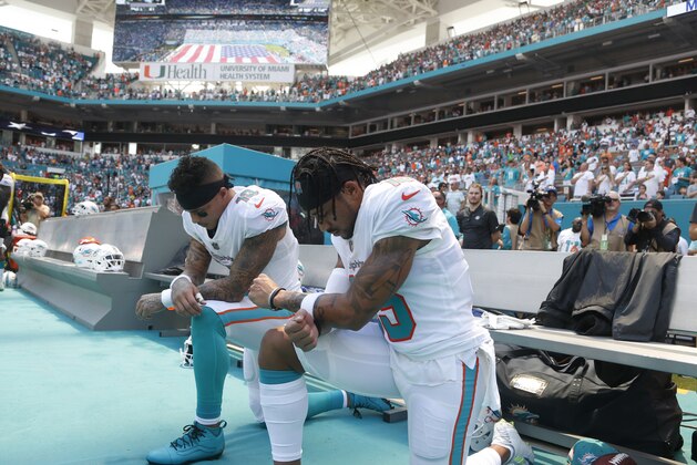 Miami Dolphins wide receiver Kenny Stills (10) and Miami Dolphins wide receiver Albert Wilson (15) kneel during the national anthem before an NFL football game against the Tennessee Titans, Sunday, Sept. 9, 2018, in Miami Gardens, Fla. (AP Photo/Wilfredo Lee)
