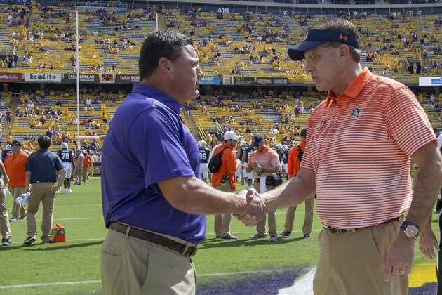 LSU head coach Ed Orgeron, left, greets Auburn head coach Gus Malzahn before an NCAA college football game in Baton Rouge, La., Saturday, Oct. 14, 2017. (AP Photo/Matthew Hinton)