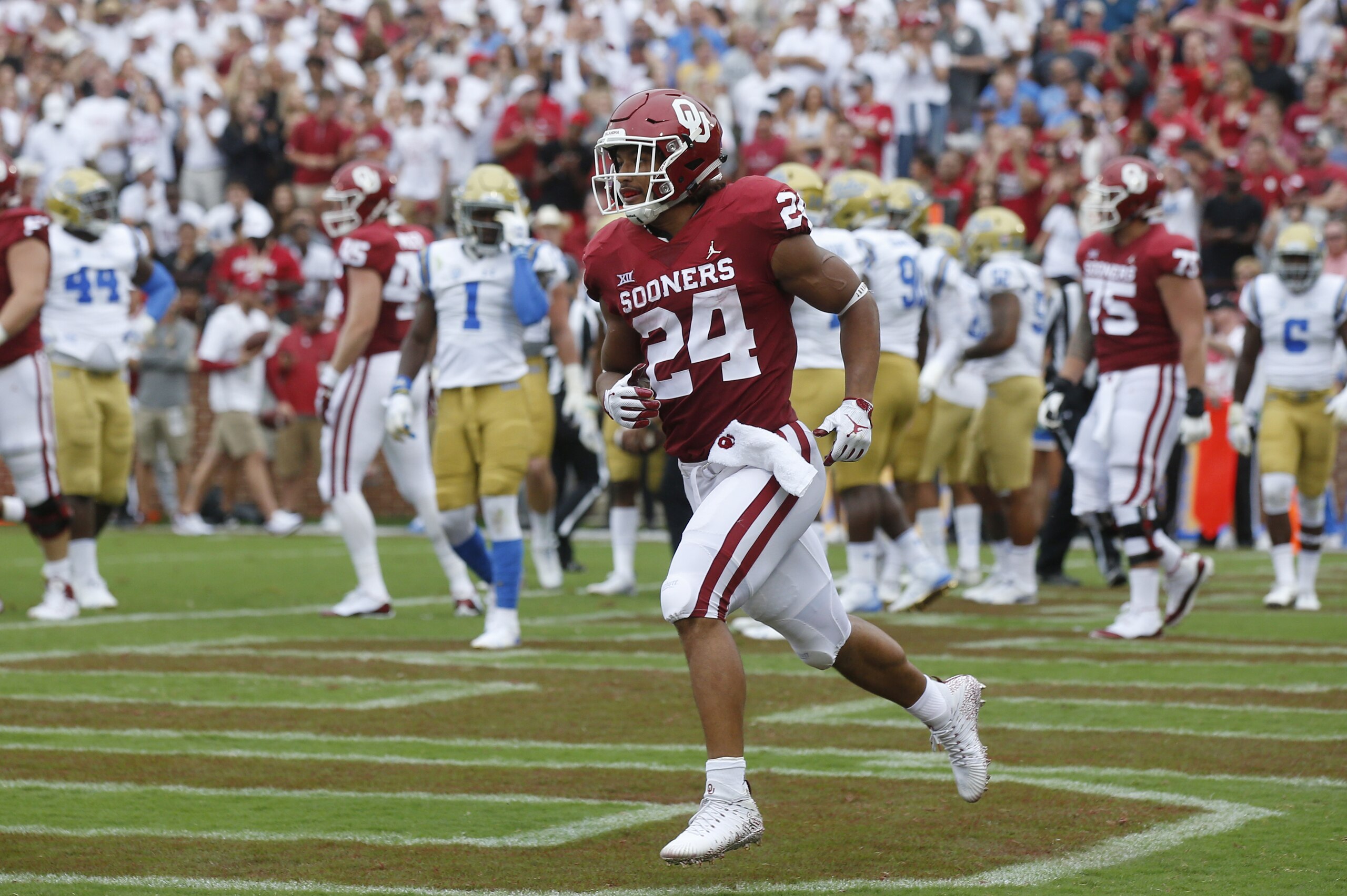 Oklahoma running back Rodney Anderson (24) celebrates after a touchdown in the first quarter of an NCAA college football game against UCLA in Norman, Okla., Saturday, Sept. 8, 2018. (AP Photo/Sue Ogrocki)