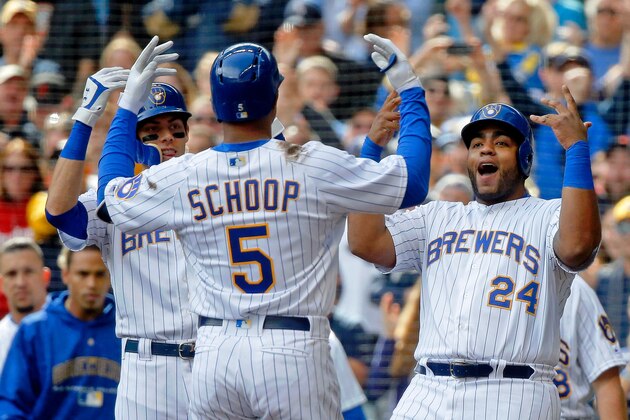 MILWAUKEE, WI - SEPTEMBER 09: Christian Yelich #22 of the Milwaukee Brewers (L) and Jesus Aguilar #24 (R) celebrate the grand slam of Jonathan Schoop #5 against the San Francisco Giants during the sixth inning at Miller Park on September 9, 2018 in Milwaukee, Wisconsin.  (Photo by Jon Durr/Getty Images)