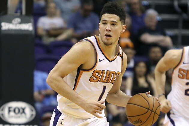 Phoenix Suns guard Devin Booker (1) advances the ball up court during the second half of an NBA basketball game against the Charlotte Hornets Saturday, Feb. 4, 2018, in Phoenix. The Hornets defeated the Suns 115-110. (AP Photo/Ralph Freso)