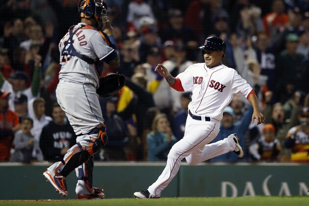 Boston Red Sox's Tzu-Wei Lin, right, scores the game-winning run in front of Houston Astros' Martin Maldonado on a single by Mitch Moreland during the ninth inning of a baseball game in Boston, Sunday, Sept. 9, 2018. (AP Photo/Michael Dwyer)