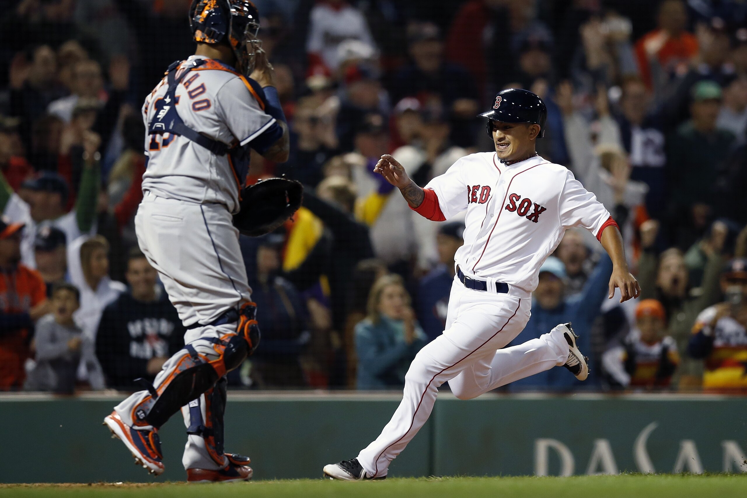 Boston Red Sox's Tzu-Wei Lin, right, scores the game-winning run in front of Houston Astros' Martin Maldonado on a single by Mitch Moreland during the ninth inning of a baseball game in Boston, Sunday, Sept. 9, 2018. (AP Photo/Michael Dwyer)