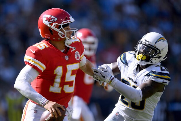 CARSON, CA - SEPTEMBER 09:  Patrick Mahomes #15 of the Kansas City Chiefs fends off the rush of Desmond King #20 of the Los Angeles Chargers during the fourth quarter in a 38-28 Chiefs win at StubHub Center on September 9, 2018 in Carson, California.  (Photo by Harry How/Getty Images)