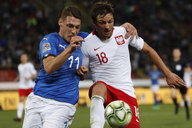 Italy's Andrea Belotti and Poland's Bartosz BereszyÅski, right, vie for the ball during the UEFA Nations League soccer match between Italy and Poland at Dall'Ara stadium in Bologna, Italy, Friday, Sept. 7, 2018. (AP Photo/Antonio Calanni)