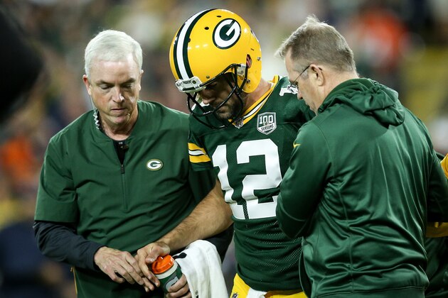 GREEN BAY, WI - SEPTEMBER 09:  Aaron Rodgers #12 of the Green Bay Packers is helped off the field after being injured in the second quarter against the Chicago Bears at Lambeau Field on September 9, 2018 in Green Bay, Wisconsin. (Photo by Dylan Buell/Getty Images)