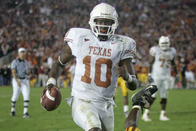 FILE - In this Jan. 4, 2006, file photo, Texas quarterback Vince Young rushes for the game-winning touchdown against Southern California during the Rose Bowl college football game in Pasadena, Calif. USC’s run at No. 1 ended in the 2006 Rose Bowl, which was also one of the best games of the decade. Texas _ led by coach Mack Brown and quarterback Vince Young _ topped the Trojans 41-38 in a back-and-forth thriller. (AP Photo/Paul Sakuma, File)