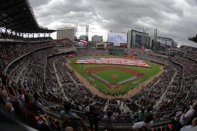 Philadelphia Phillies and Atlanta Braves line the infield as fighter jets fly overhead during the national anthem before an opening day baseball game at SunTrust Park, Thursday, March 29, 2018, in Atlanta. (AP Photo/John Bazemore)