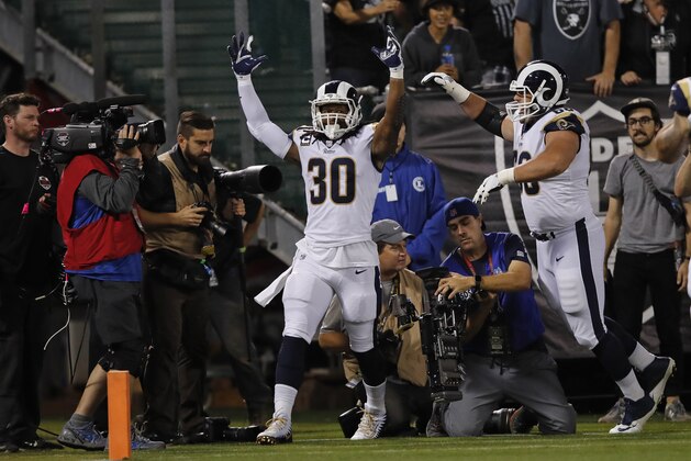 Los Angeles Rams running back Todd Gurley, left, celebrates after scoring a touchdown as teammate Austin Blythe, right, looks on during the first half of an NFL football game against the Oakland Raiders in Oakland, Calif., Monday, Sept. 10, 2018. (AP Photo/John Hefti)