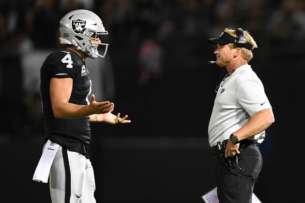 OAKLAND, CA - SEPTEMBER 10:  Derek Carr #4 of the Oakland Raiders speaks with head coach Jon Gruden during their NFL game against the Los Angeles Rams at Oakland-Alameda County Coliseum on September 10, 2018 in Oakland, California.  (Photo by Thearon W. Henderson/Getty Images)