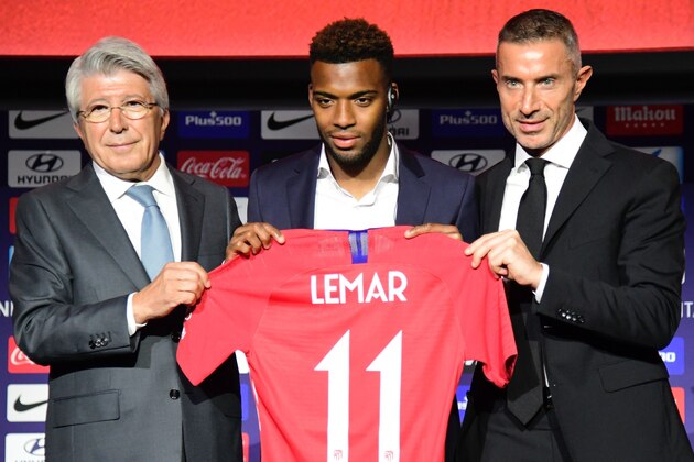 Atletico Madrid's new French midfielder Thomas Lemar (C) poses with his new jersey along with Atletico Madrid president Enrique Cerezo (L) and the club's sports director Andrea Berta during his official presentation at the Wanda Metropolitano Stadium in Madrid on July 30, 2018. (Photo by JAVIER SORIANO / AFP)        (Photo credit should read JAVIER SORIANO/AFP/Getty Images)