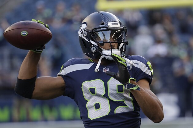 Seattle Seahawks wide receiver Doug Baldwin (89) passes the ball during warmups before an NFL football preseason game against the Oakland Raiders, Thursday, Aug. 30, 2018, in Seattle. (AP Photo/Elaine Thompson)